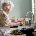 Grandmother cleaning vegetables