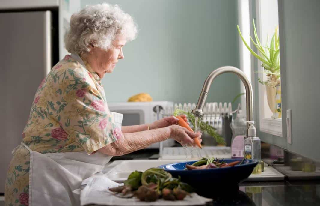 Grandmother cleaning vegetables