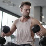 sportsman-exercising-with-dumbbells