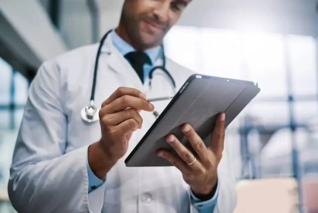 Healthcare And Medicine. Doctor using a digital tablet